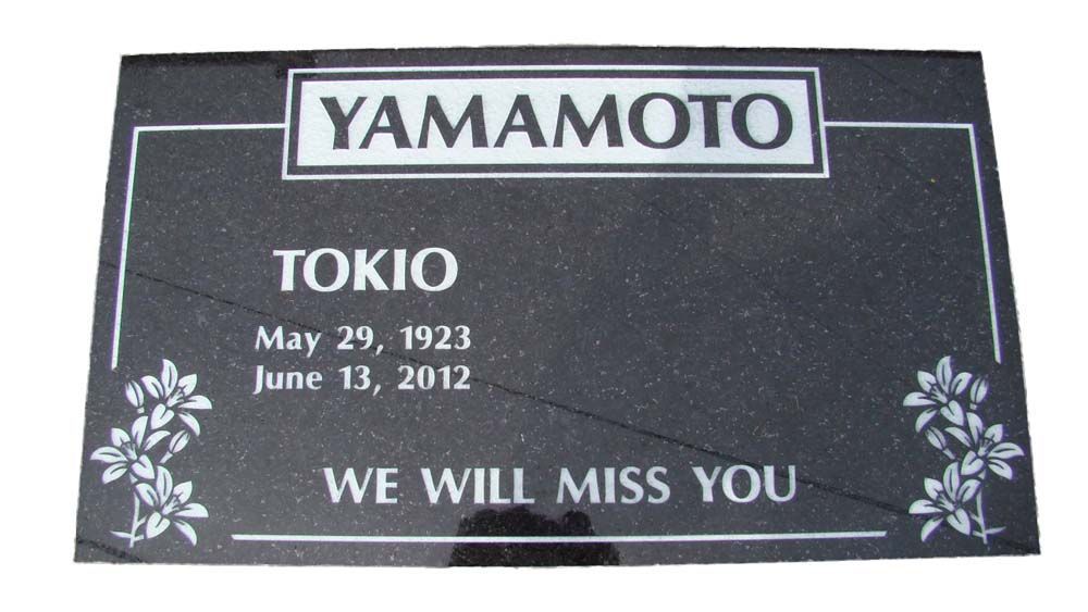 A black granite grave marker for yamamoto tokio
