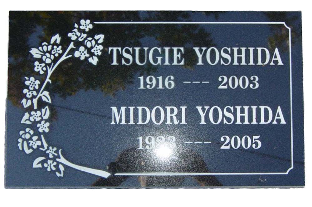 A grave marker for tsugie yoshida and midori yoshida