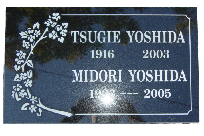 A grave marker for tsugie yoshida and midori yoshida