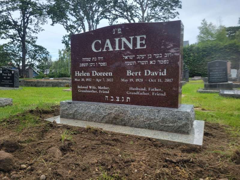 a gravestone in a cemetery with the name caine on it