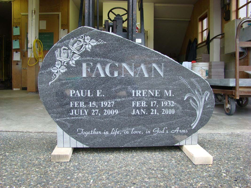 A gravestone for paul fagnan sits in a garage