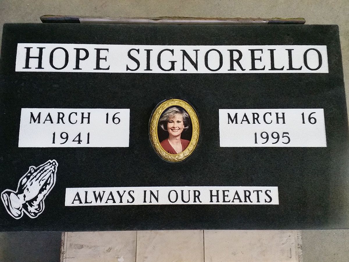 a black sign that says hope signorello on it