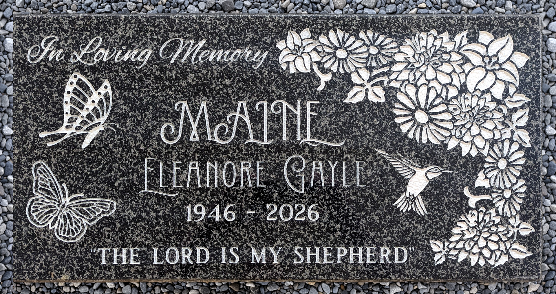 A dark grey headstone that measures 12