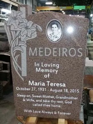 a gravestone is sitting on a conveyor belt in a factory .