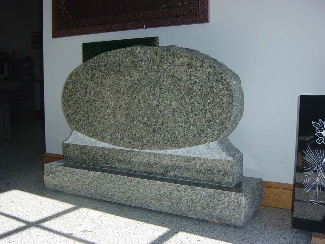 a gravestone is sitting on the floor in a room next to a window .