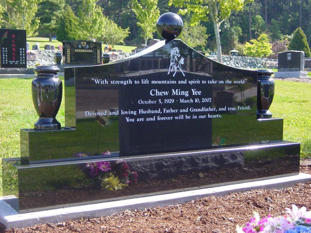 A gravestone in a cemetery has the name chow ming yee on it