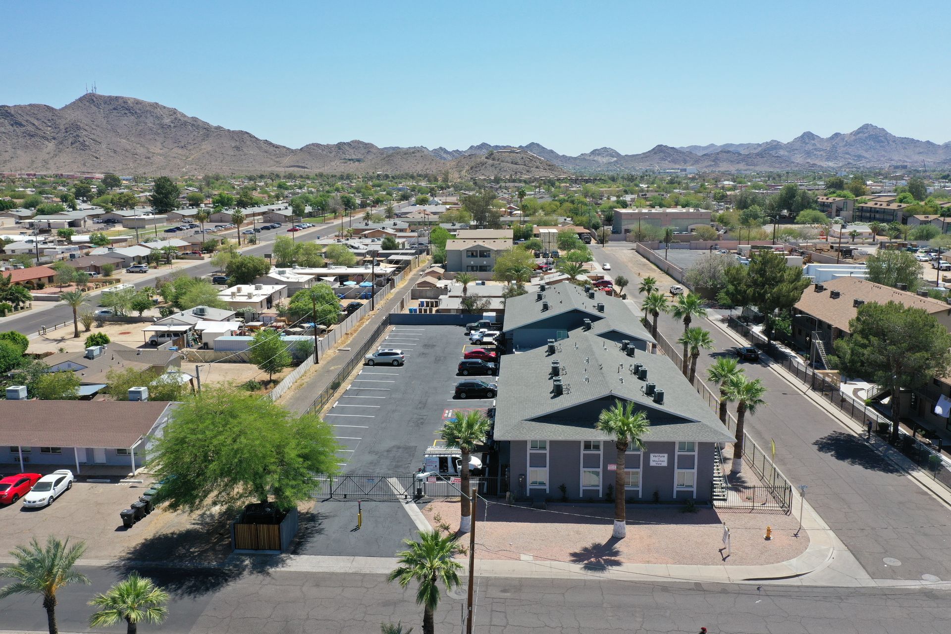 An aerial view of a residential area with mountains in the background