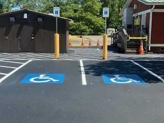 A row of cars are parked in a parking lot