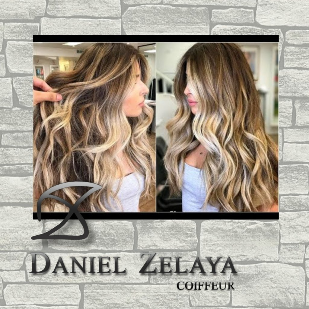 Una mujer con cabello largo y rubio está parada frente a una pared de ladrillos.