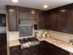 Dark brown kitchen with granite countertop, range, and cabinets.