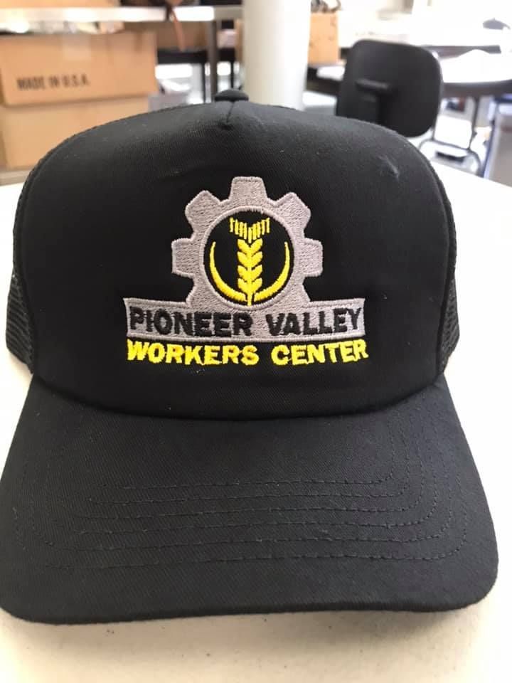 Black cap with Pioneer Valley Workers Center logo: gear, wheat, text.