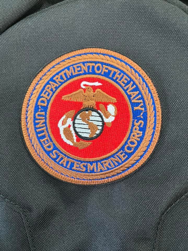 Embroidered U.S. Marine Corps patch on a dark gray background. Features eagle, globe, and anchor emblem with text 