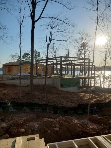 A house is being built next to a body of water