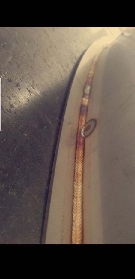 A close up of a rusty fender on a car