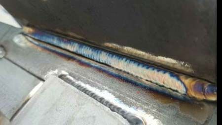 A close up of a welding joint on a piece of metal.