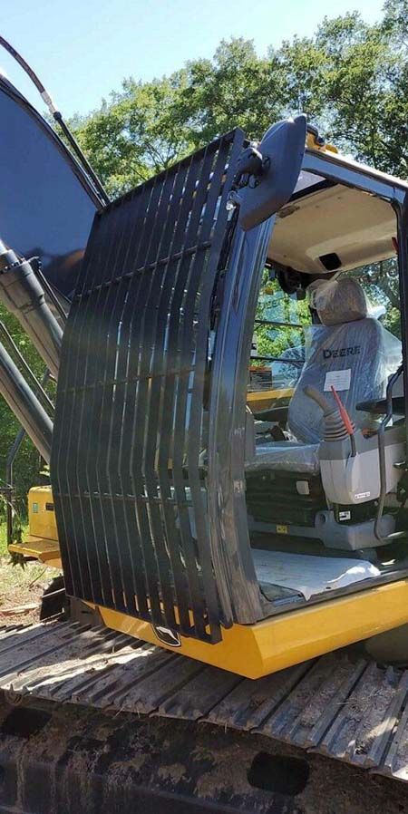 The inside of a yellow excavator with the door open.