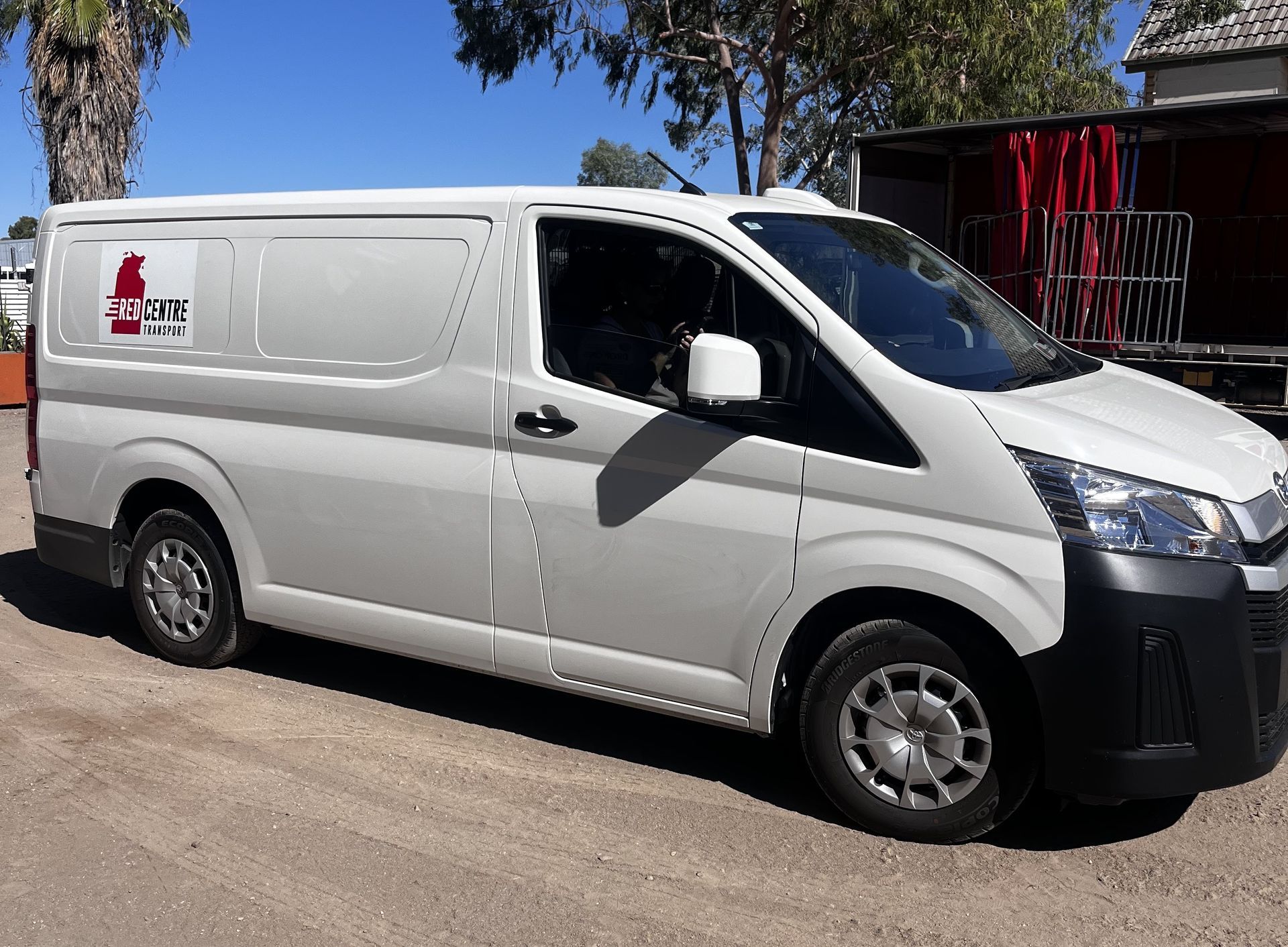 White delivery vans parked in a row on a paved surface. — Red Centre Transport in Braitling, NT
