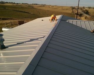 Staff Working on a Metal Roof — Elk Horn, IA — Modern Roofing LLC