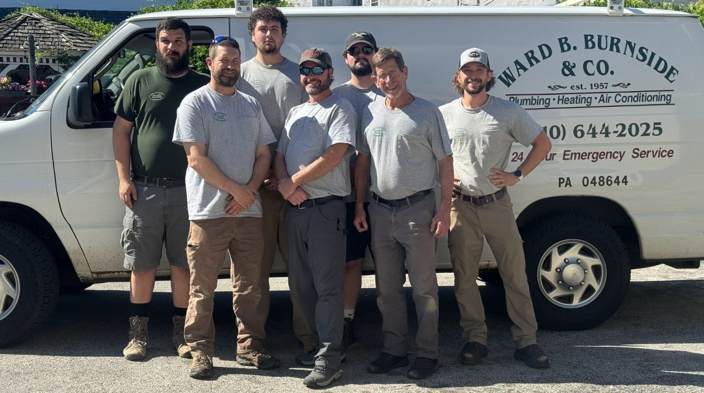 Employees standing in front of a the company van - Plumbing in Berwyn, PA