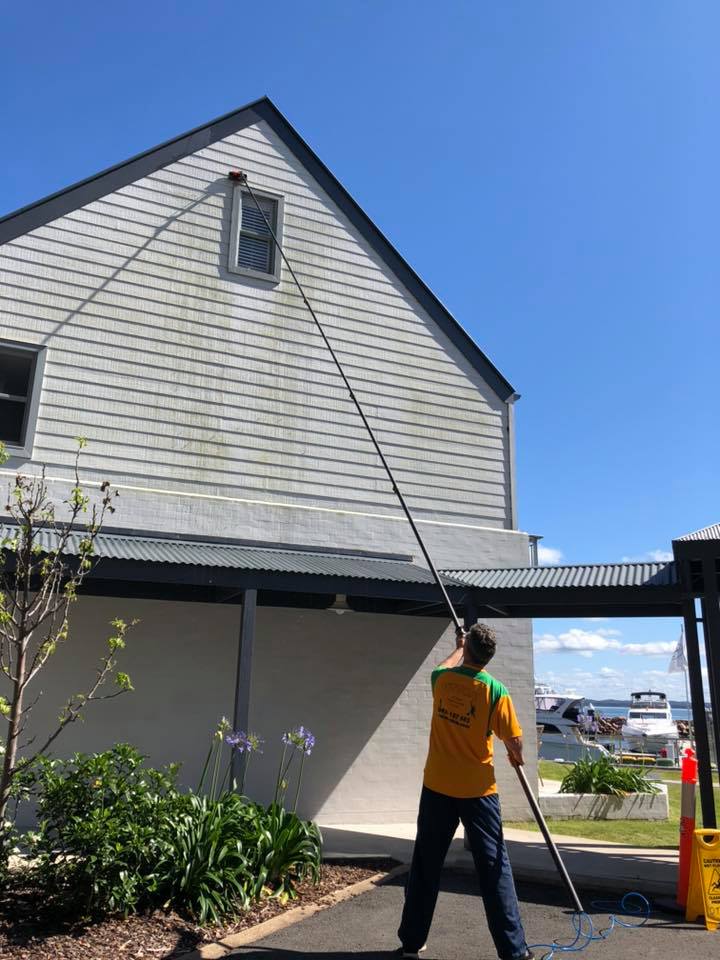 cleaning house exterior with water fed pole system