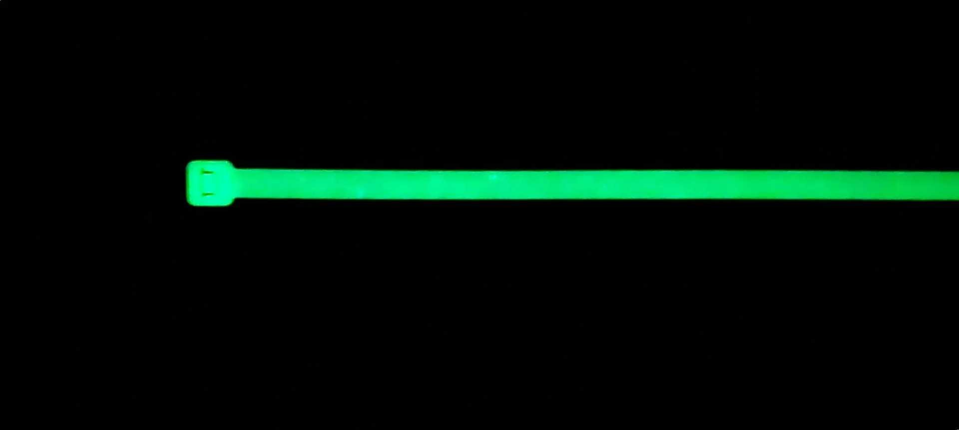 QuickSpot glow-in-the-dark cable tie on a dark background