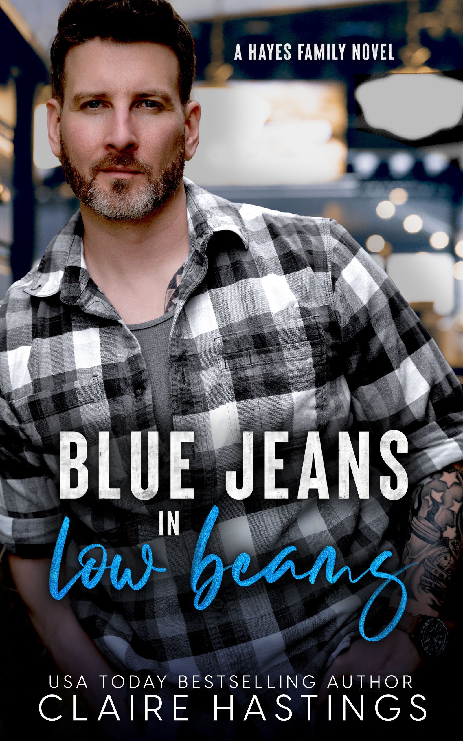 A man in a plaid shirt is on the cover of a book called Blue Jeans in Low Beams by Claire Hastings.