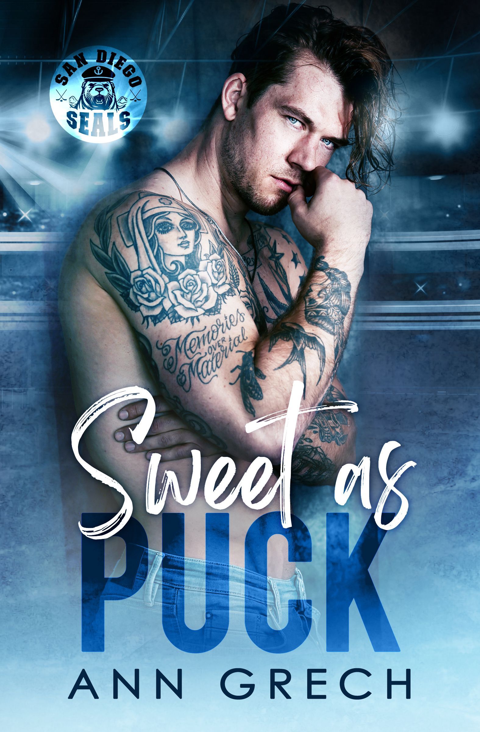 A man with a lot of tattoos on his arms is on the cover of a book called Sweet as Puck by Ann Grech.