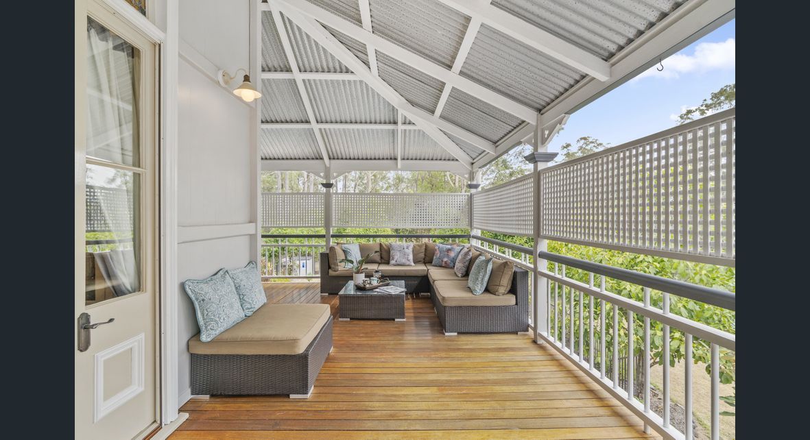 There is a porch with a couch and a table on it — Painter In Sunshine Coast, QLD