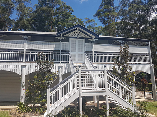 A large white house with stairs leading up to the second floor — Painter In Sunshine Coast, QLD