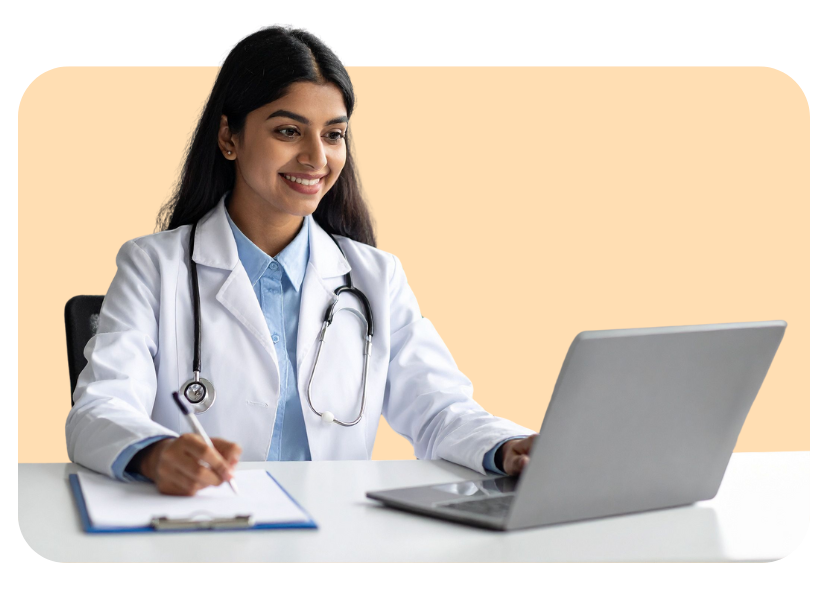 Doctor wearing a lab coat, using a laptop and taking notes.
