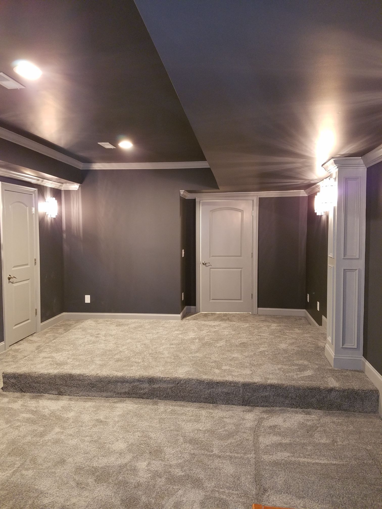 an empty room with a stage in the middle of it