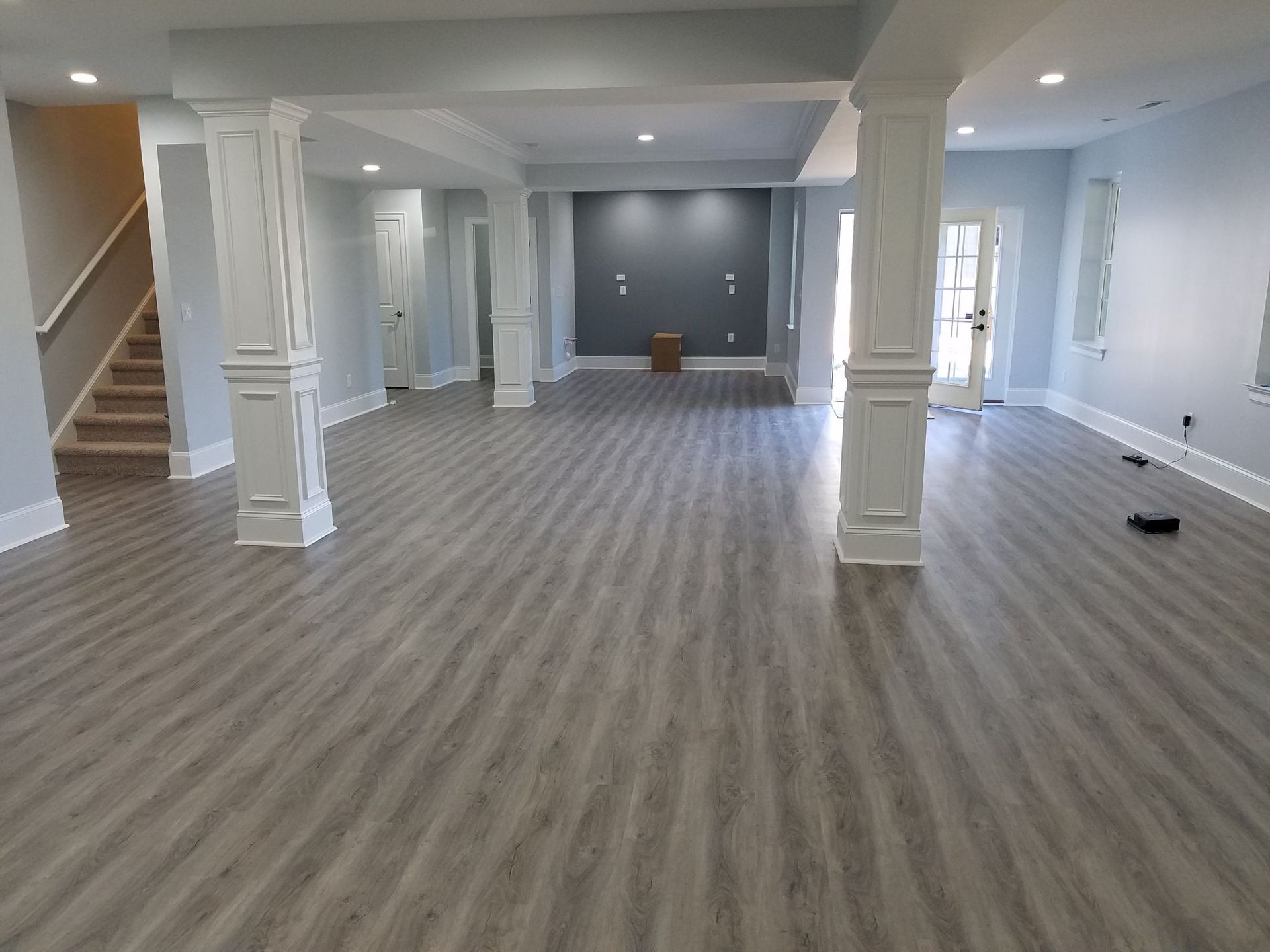a large empty room with a staircase and columns