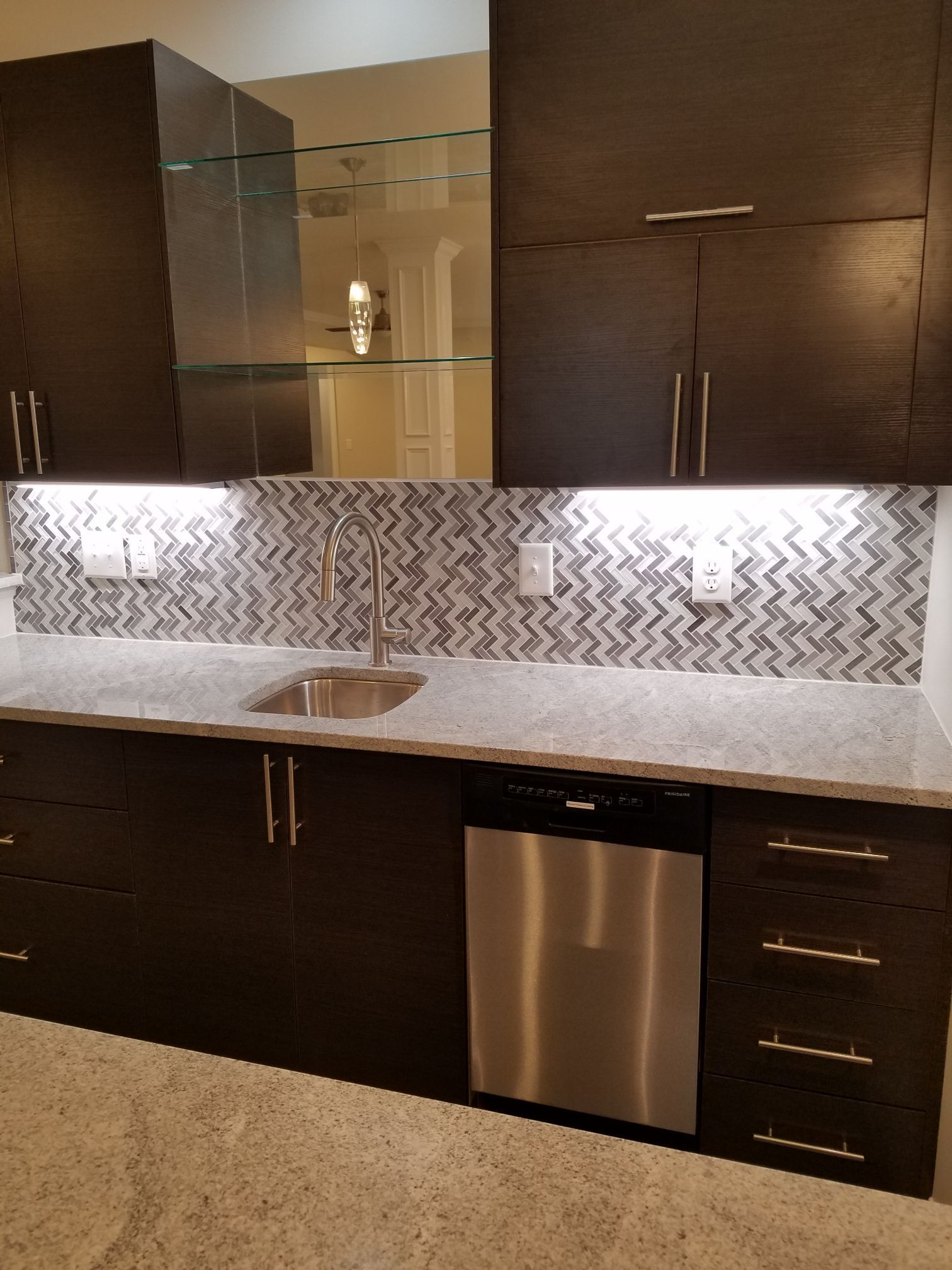 a kitchen with a sink and a stainless steel dishwasher