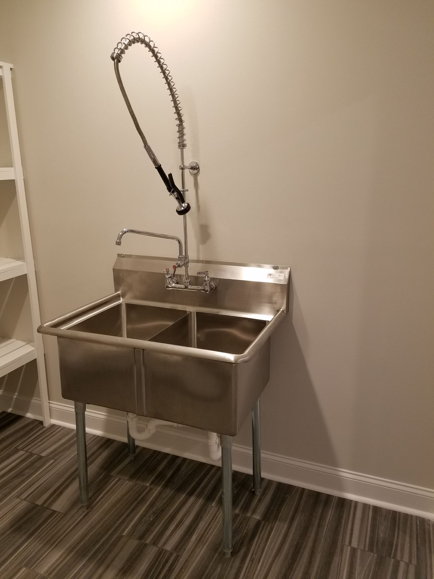 a stainless steel sink with a faucet attached to it
