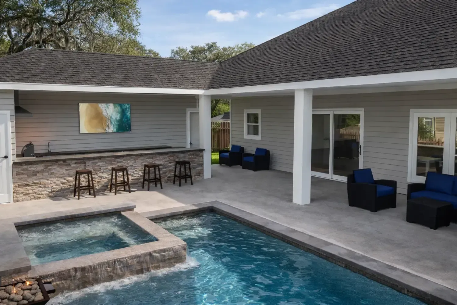 A modern covered patio with an outdoor bar, hot tub, swimming pool, and comfortable lounge seating.