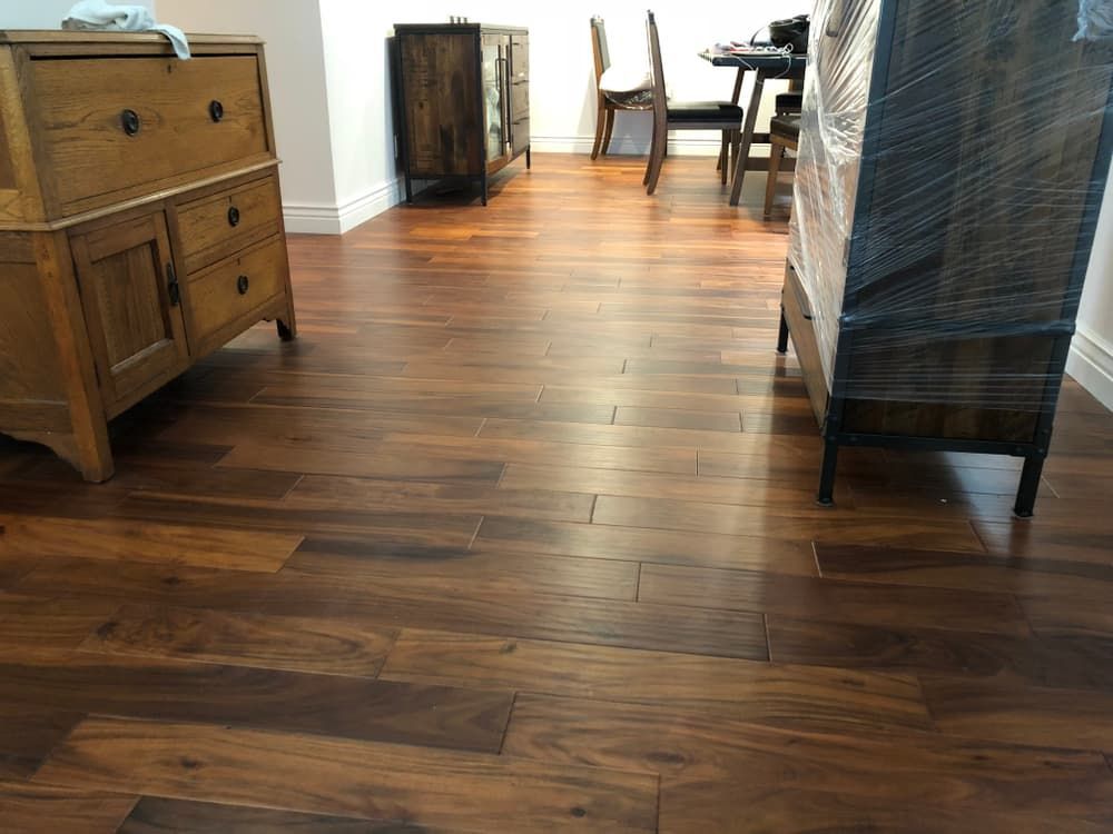 A Wooden Floor in A Living Room with A Dresser and Chairs — More on the Floor in Barrack Heights, NSW