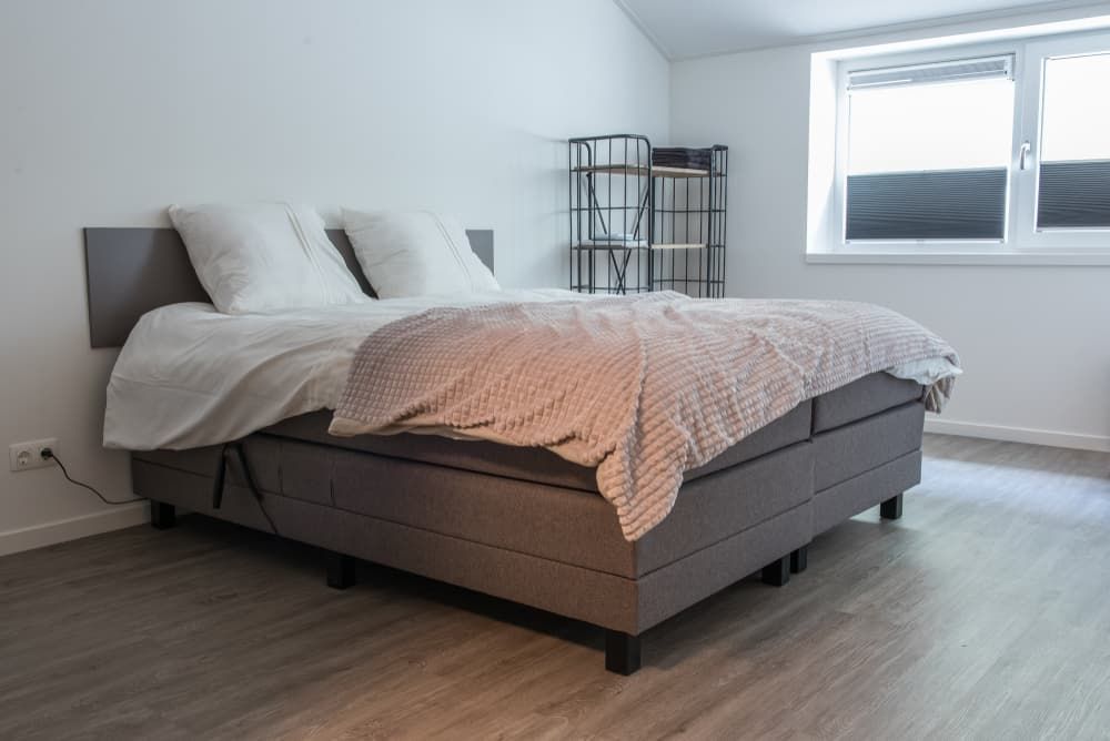 A Bed Is Sitting in A Bedroom Next to A Window — More on the Floor in Barrack Heights, NSW