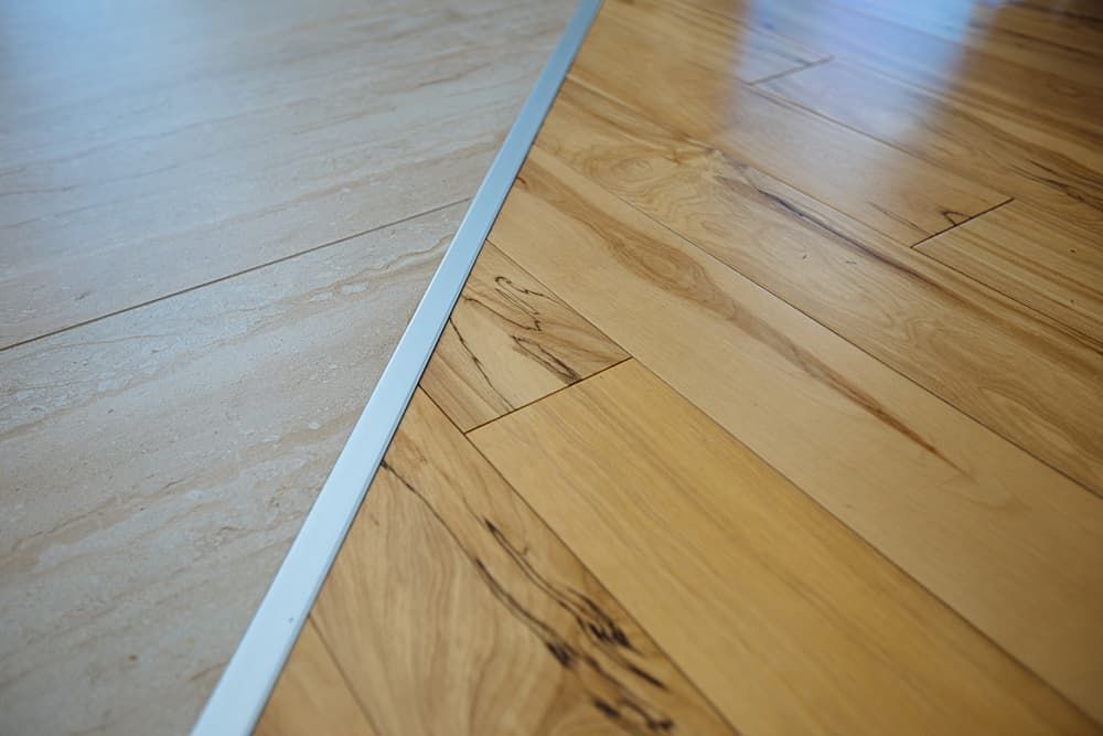 A Close up Of a Wooden Floor with A Metal Trim — More on the Floor in Dapto, NSW