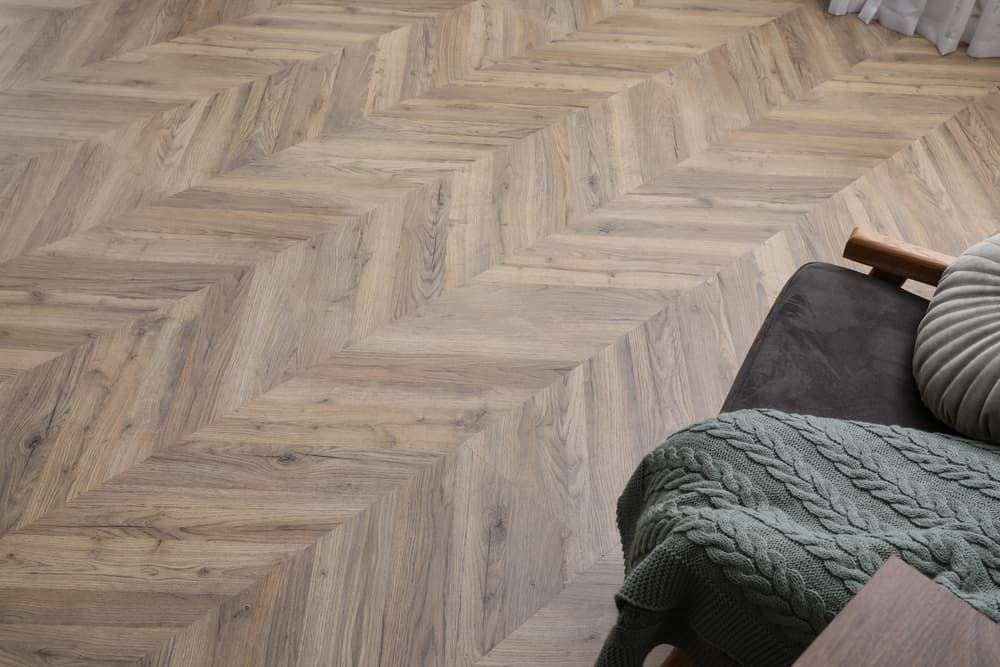 A Wooden Floor with A Herringbone Pattern in A Living Room — More on the Floor in Barrack Heights, NSW