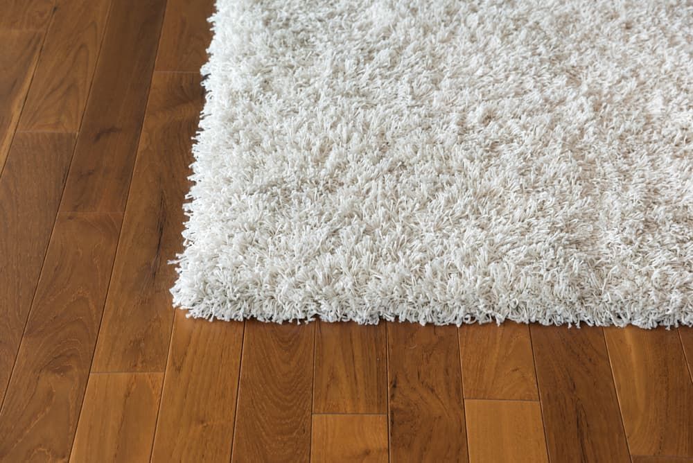 A White Rug Is Sitting on A Wooden Floor — More on the Floor in Barrack Heights, NSW