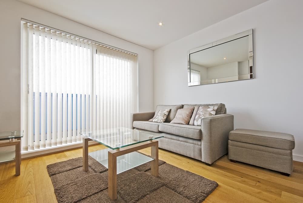 A Living Room with A Couch and Mirror — More on the Floor in Kiama, NSW