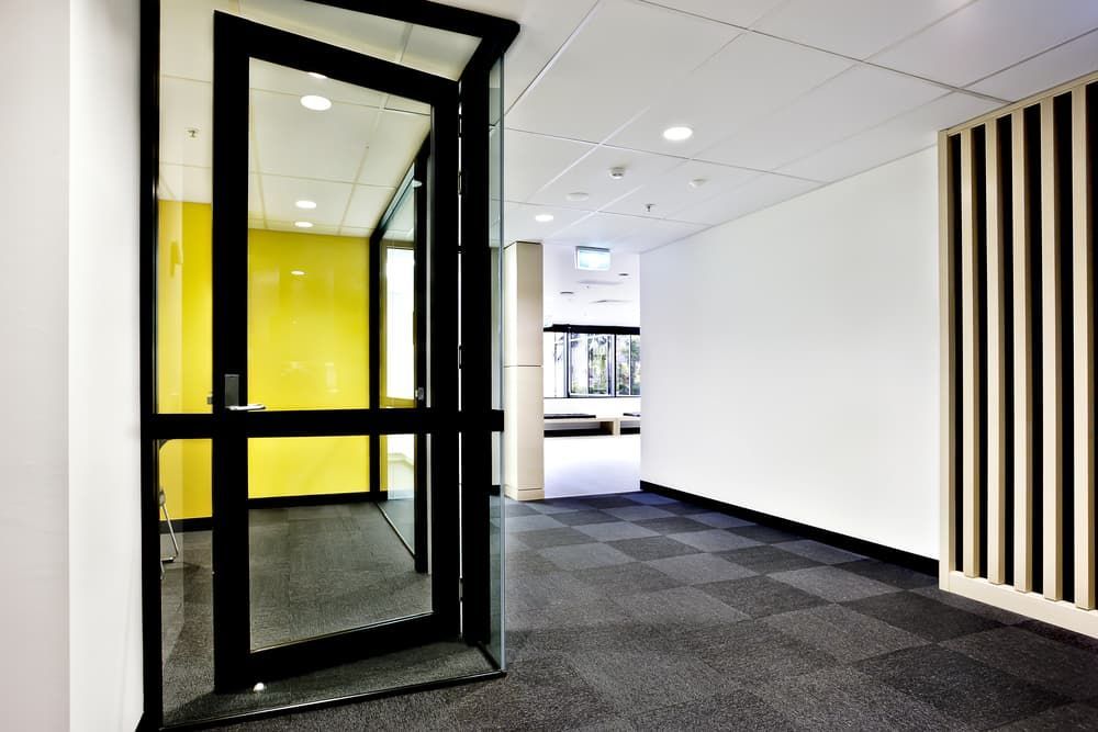 A Hallway with A Glass Door and A Yellow Wall — More on the Floor in Barrack Heights, NSW