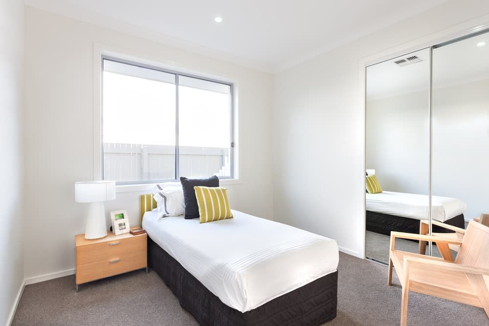 A Bedroom with A Single Bed, Chair and Mirrors — More on the Floor in Barrack Heights, NSW
