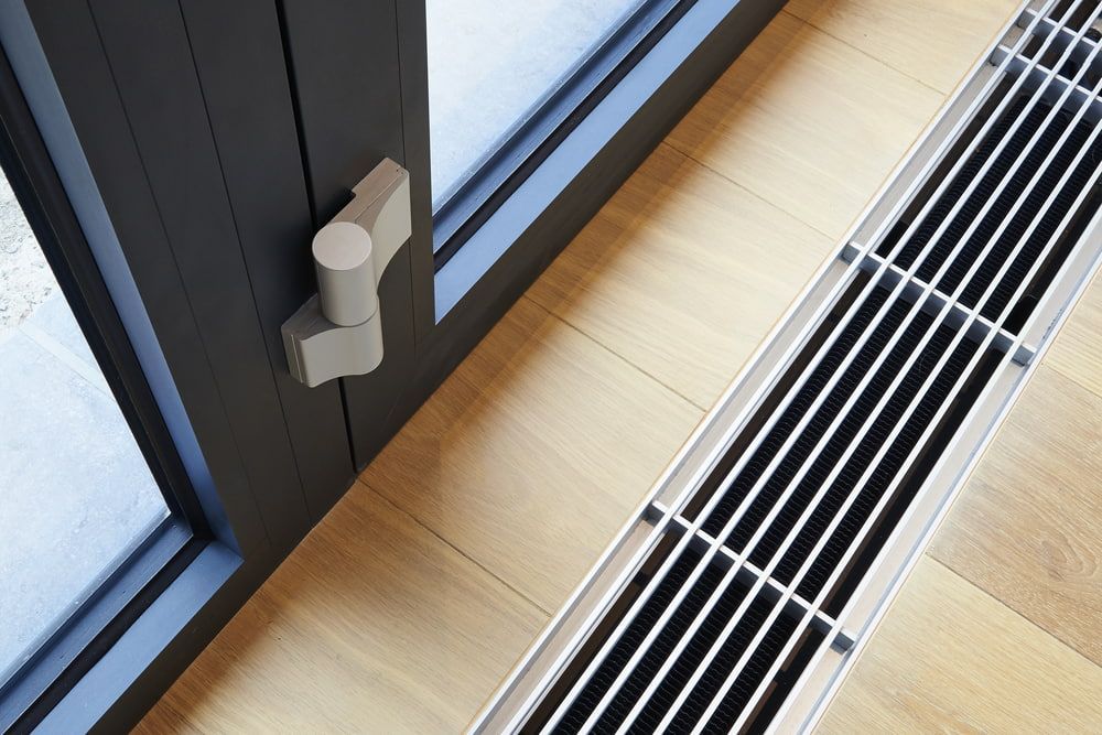 A Sliding Glass Door with A Radiator Underneath It — More on the Floor in Barrack Heights, NSW