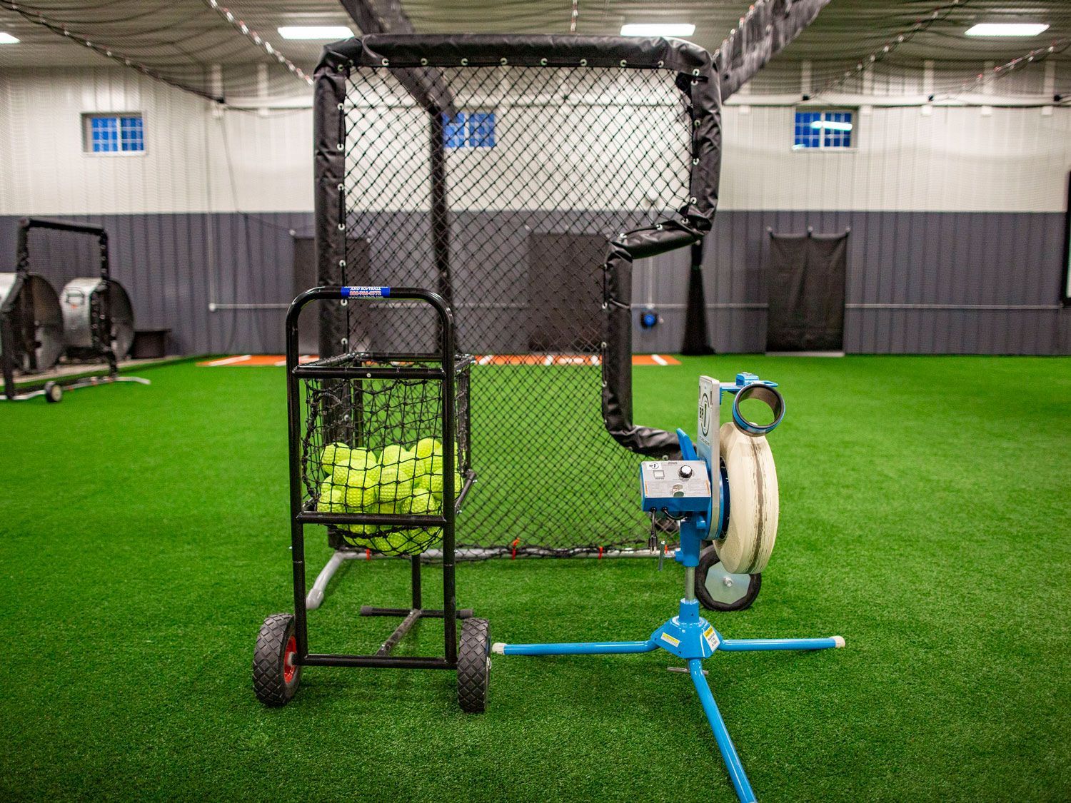 A ball machine is sitting at the practice facility Home Turf.