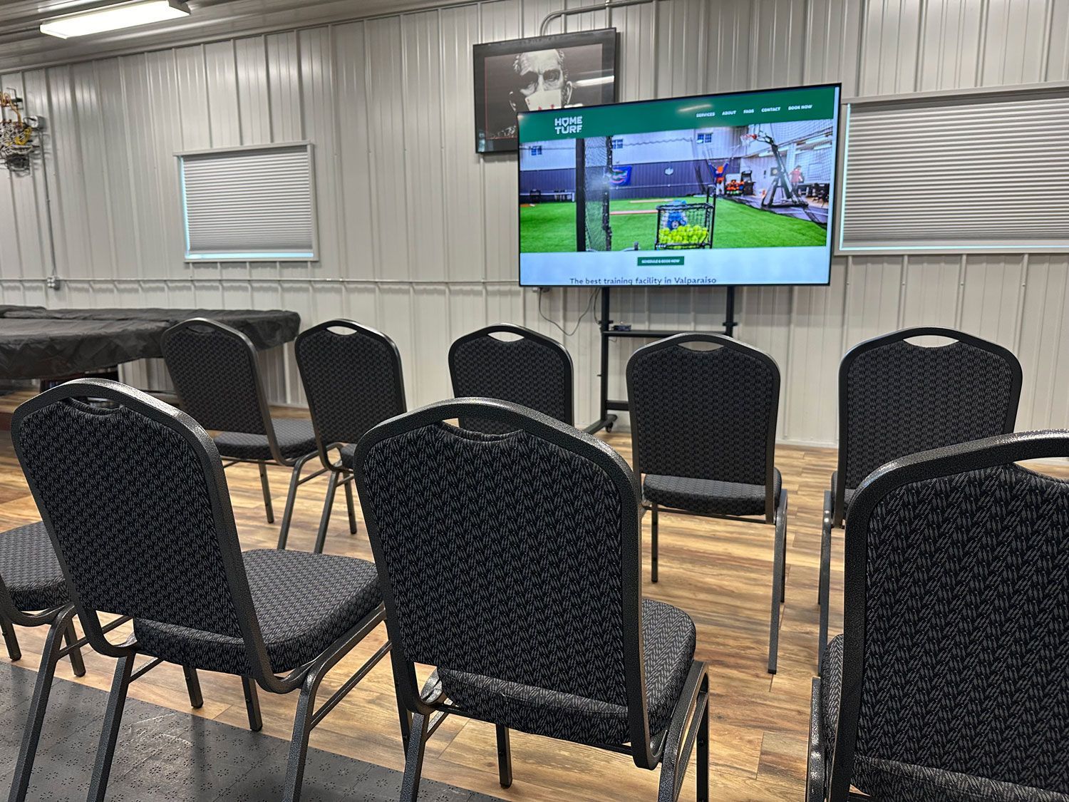 A row of chairs are lined up on a wooden floor at Home Turf.