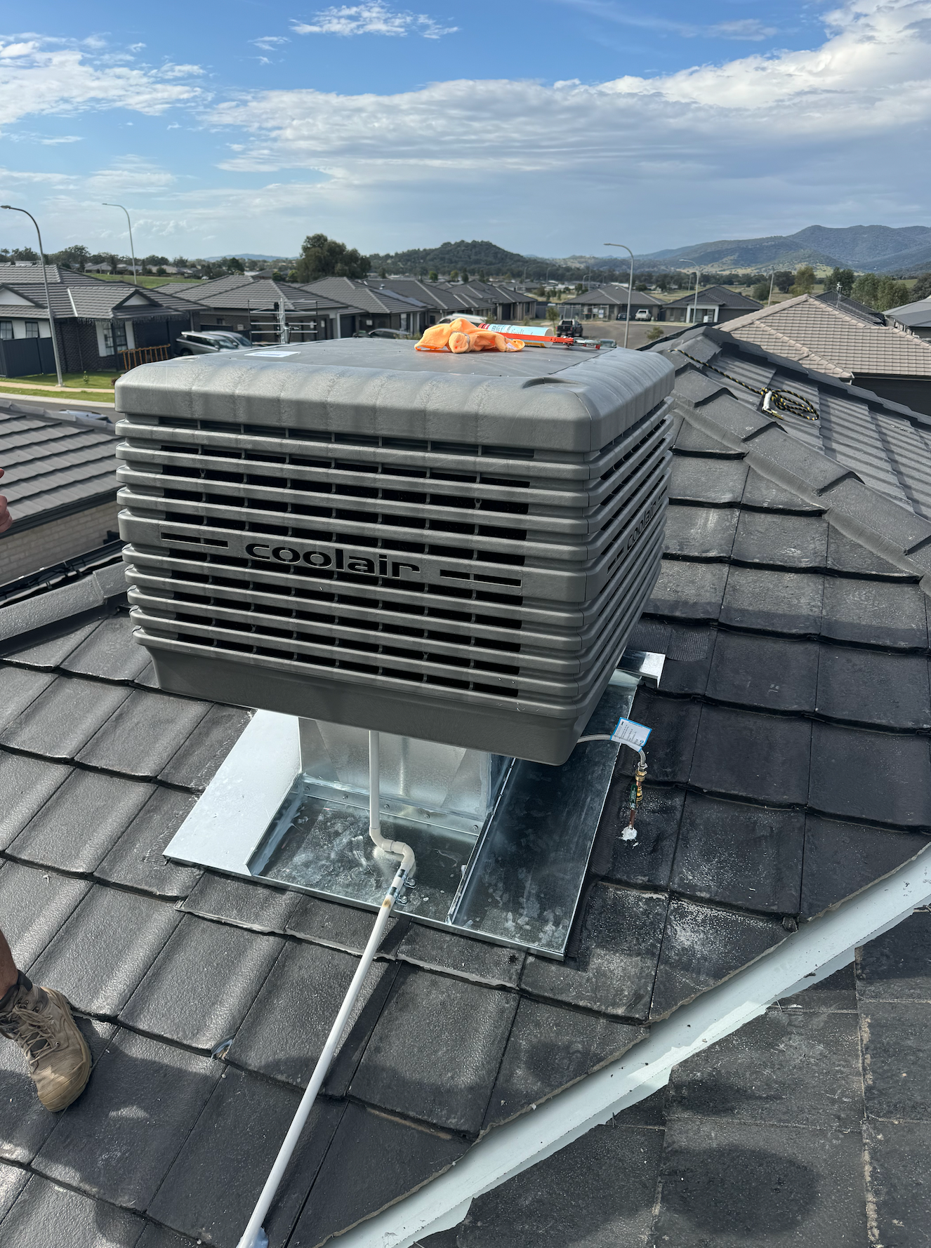 A Large Air Conditioner Is Sitting On Top Of A Roof — Rid-Arc Electrical In Tamworth, NSW