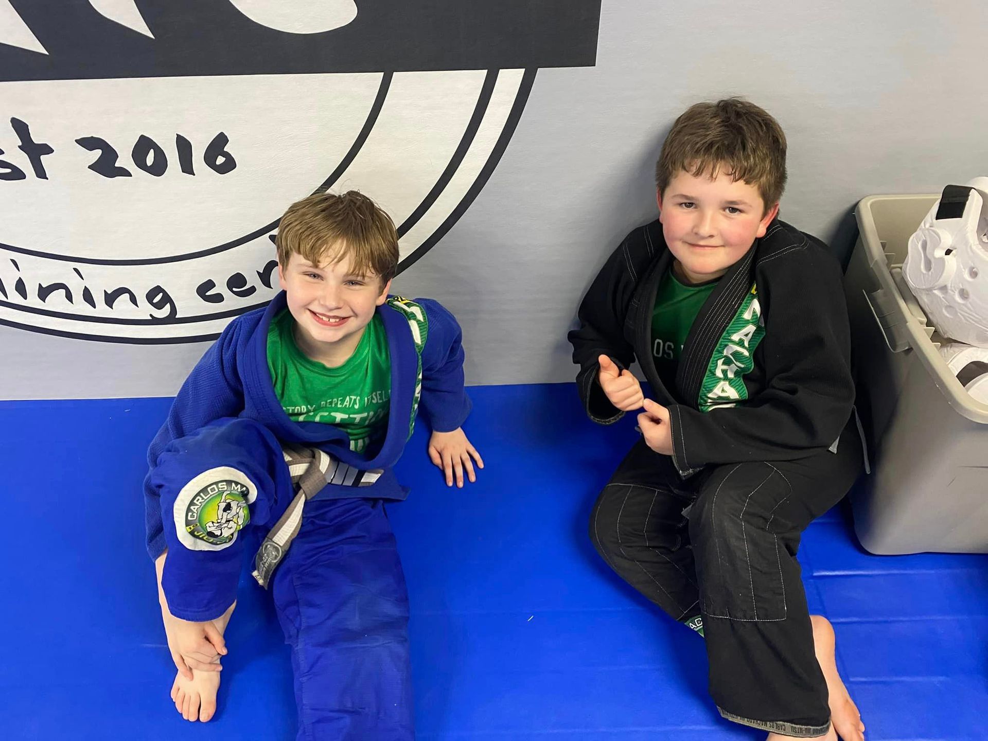 Kids celebrating achievement with martial arts belts