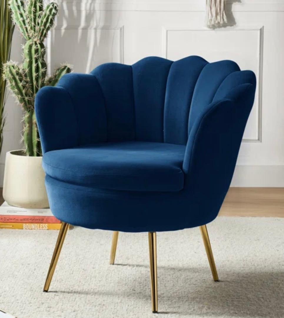 Blue velvet scallop chair with gold legs.