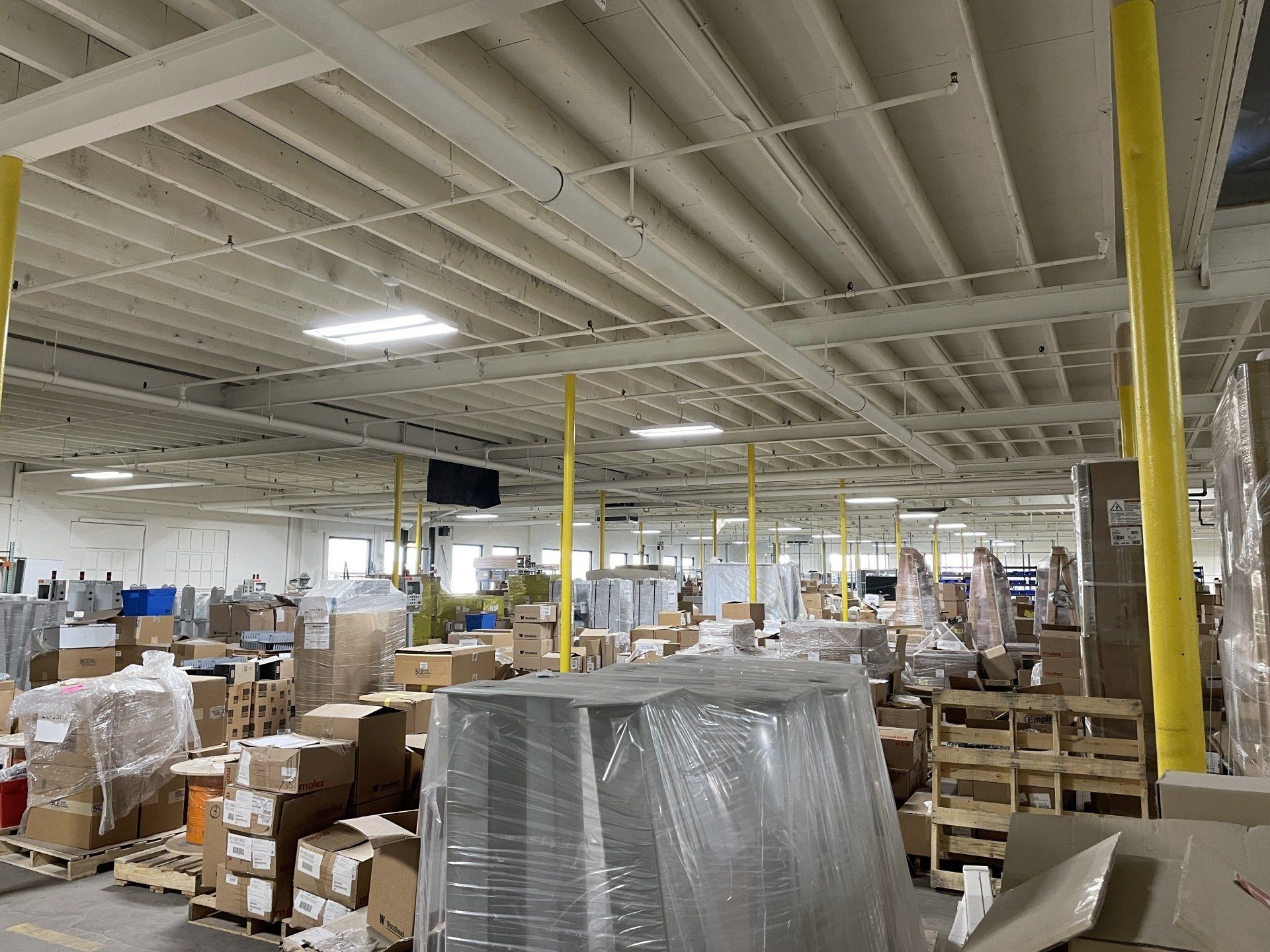 A large warehouse filled with lots of boxes and pallets.